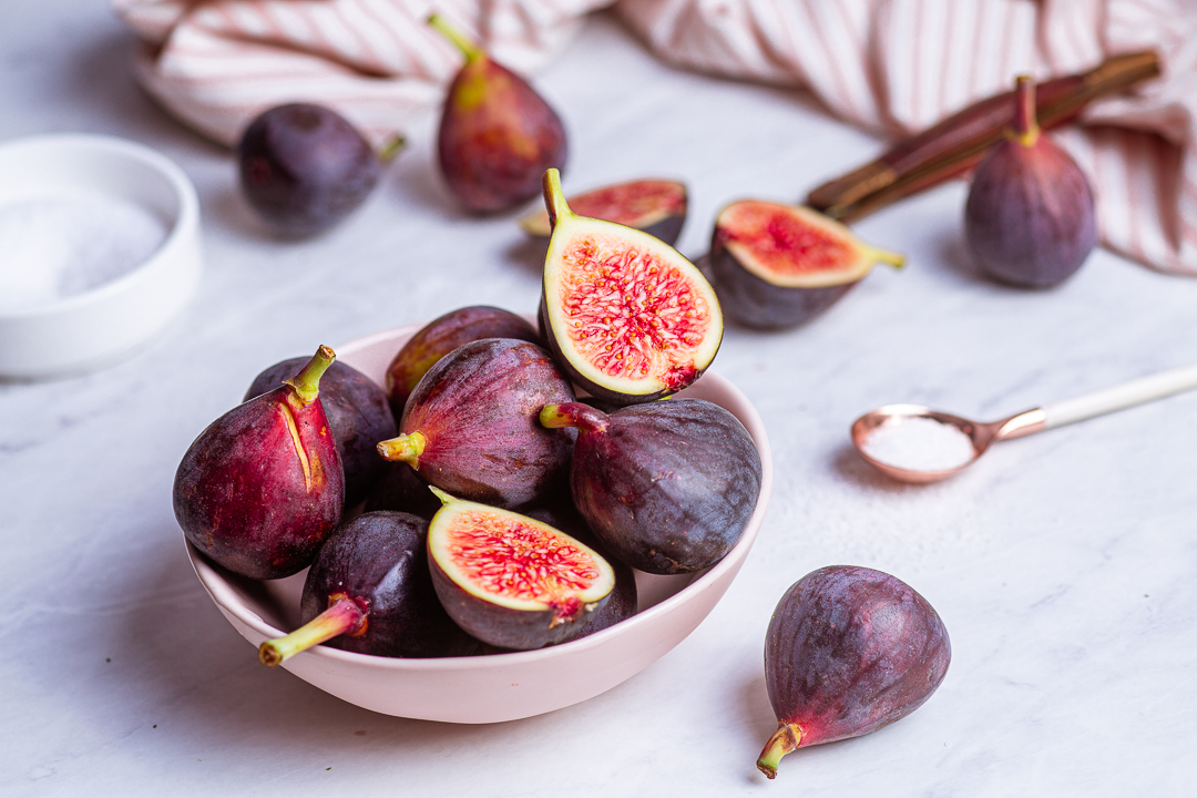 Red figs in a pink bowl